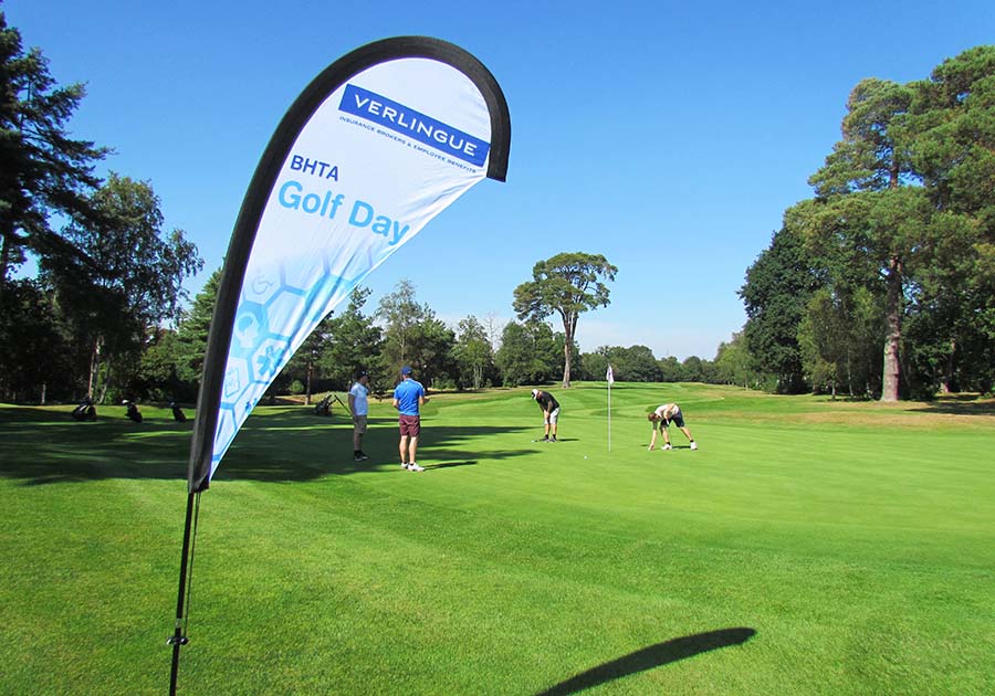 BHTA-Golf-Day-2021- Players on course with BHTA flag
